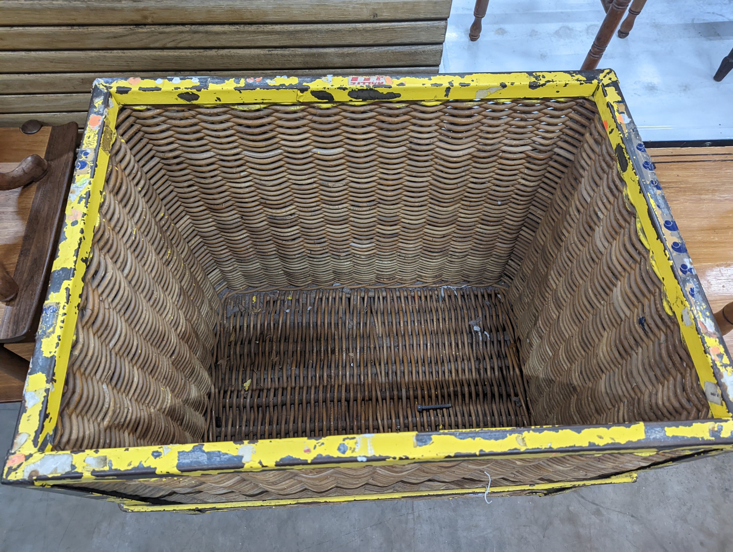 A vintage wicker and iron laundry basket on wheels, width 85cm, depth 61cm, height 87cm